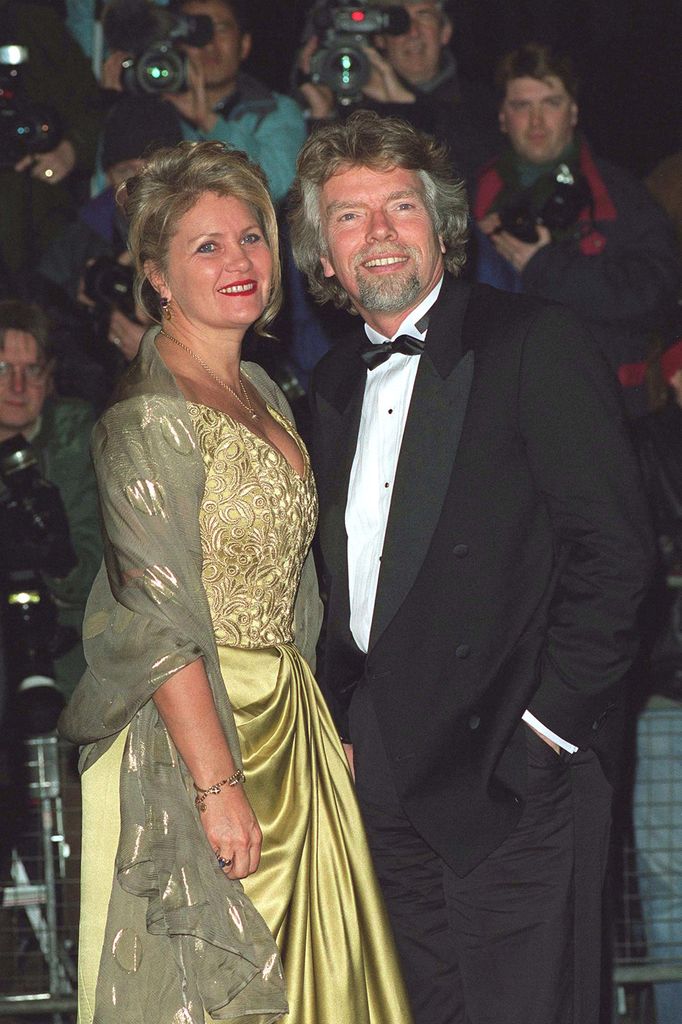 Business entrepreneur Sir Richard Branson in bow tie and tuxedo and wife Joan in a yellow dress