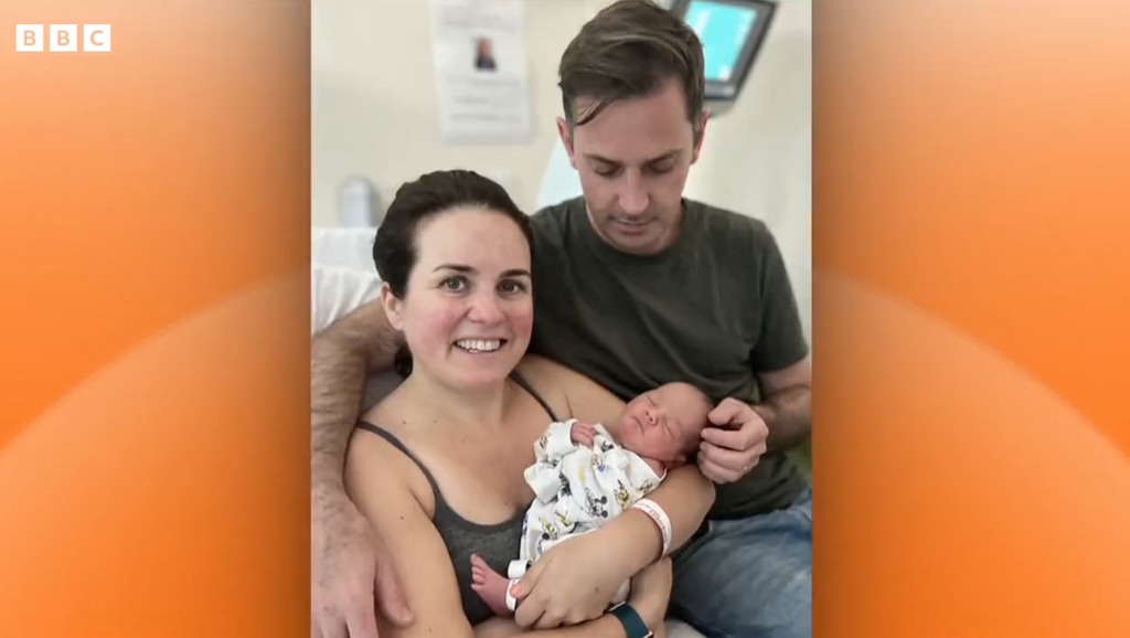 Nina Warhurst and husband Ted cradling newborn baby