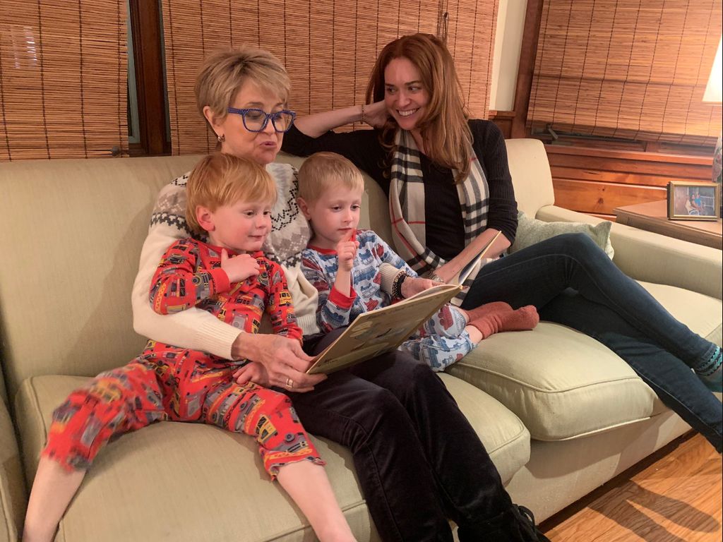 Jane Pauley reading to two young boys in pyjamas