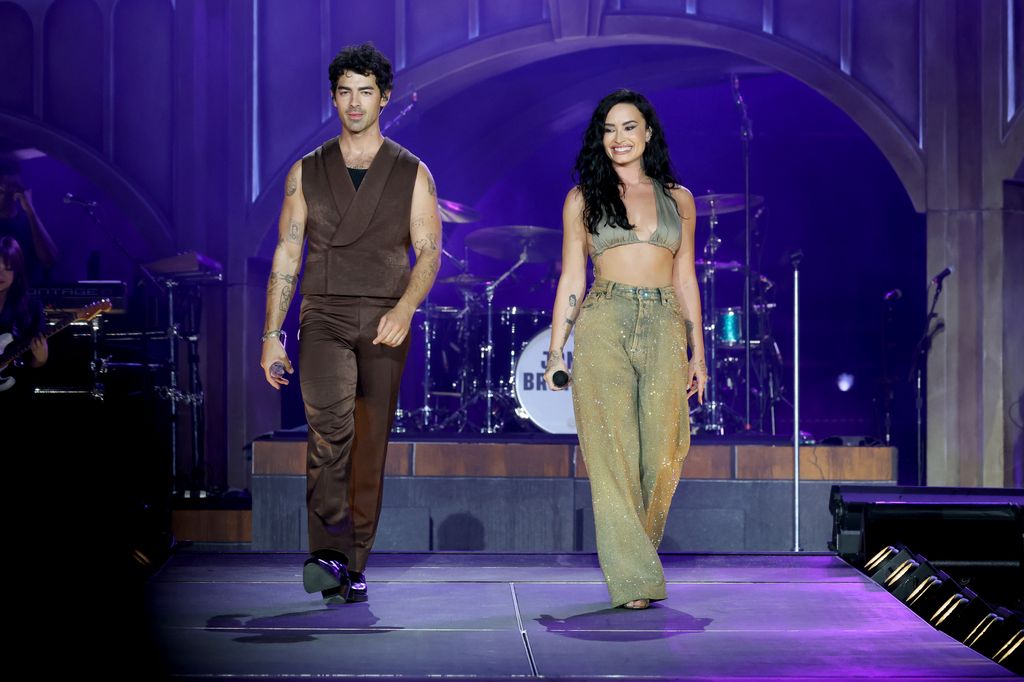 Joe Jonas and Demi Lovato perform onstage during the Jonas Brothers: JONAS20 Greetings From Your Hometown tour 