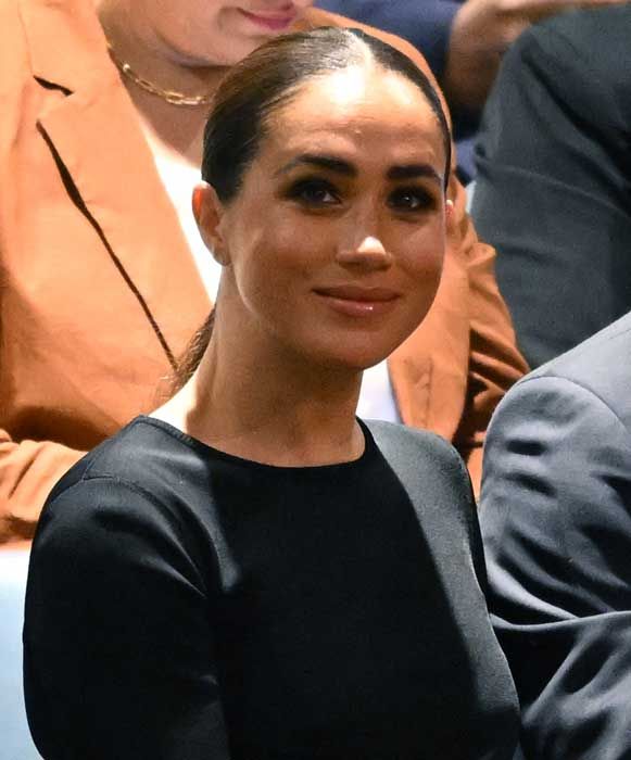 meghan markle smiling in a black top