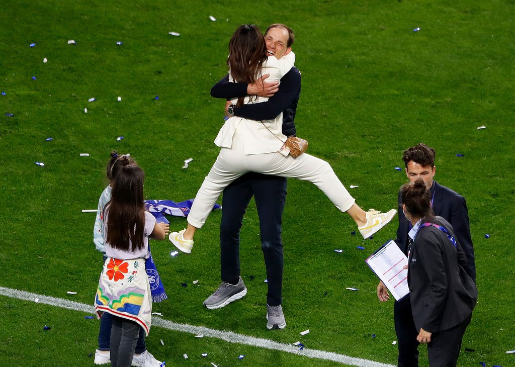 Sissi Tuchel jumping into the arms of Thomas Tuchel on a football field