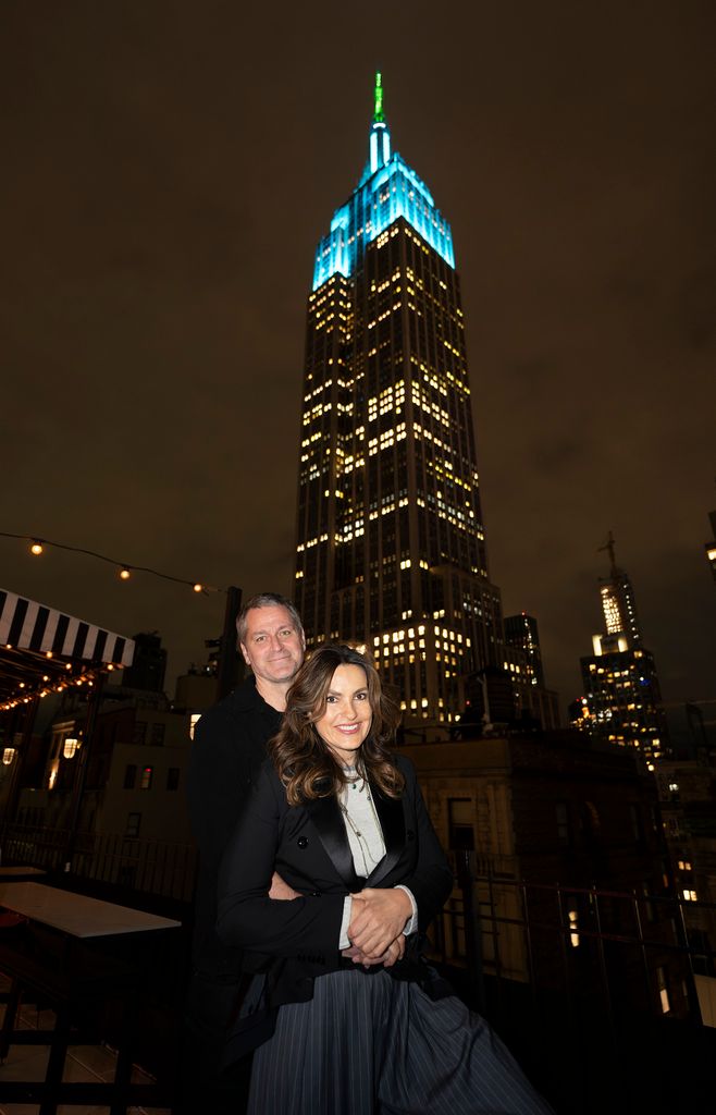 LAW & ORDER: SPECIAL VICTIMS UNIT -- Empire State Building lit in honor of SVU's 25th Season and Sexual Assault Awareness Month -- Pictured: (l-r) Peter Hermann; Mariska Hargitay, Founder, Joyful Heart Foundation -- (Photo by: Charles Sykes/NBC via Getty Images)