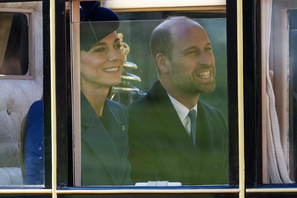 William and Kate smile during the carriage procession