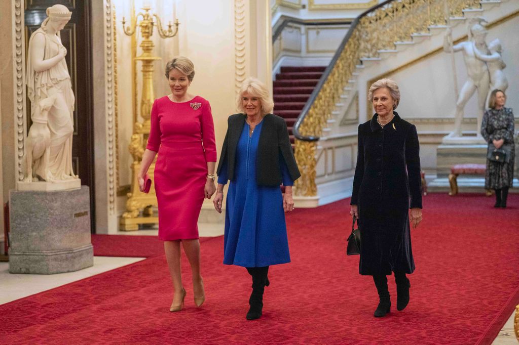 Queen Mathilde, Queen Camilla and Duchess of Gloucester walk through Buckingham Palace