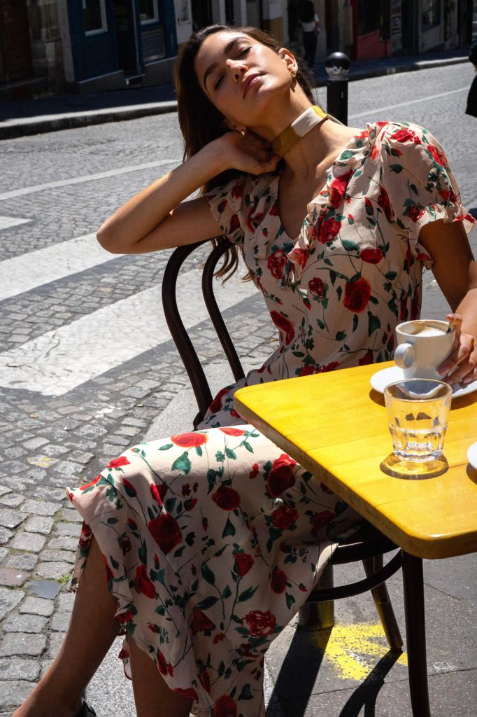 woman on the street ina. floral dress by rixo