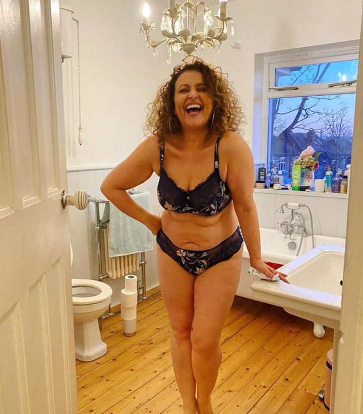 Nadia Sawalha standing in a bathroom in lingerie