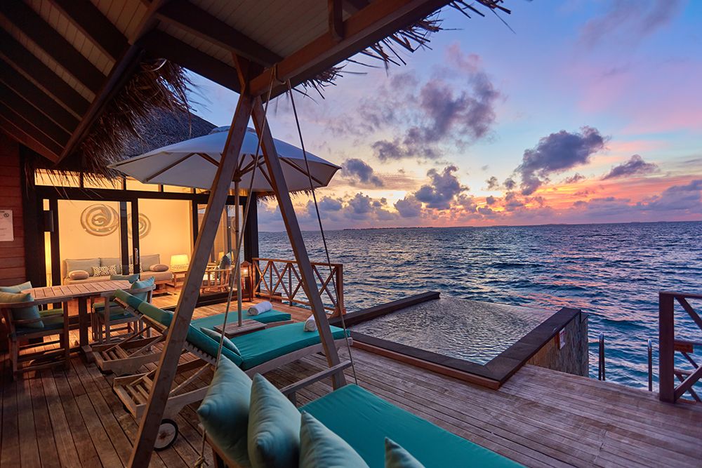 A sunset view from the deck of a water villa 