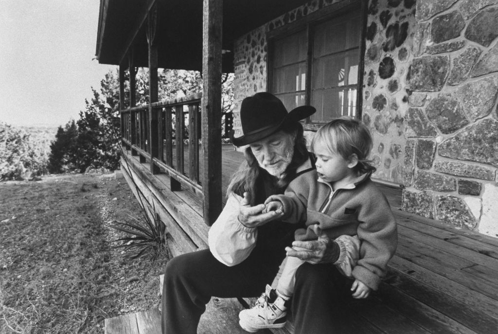 Willie  with his son Lukas on the front steps of his cabin
