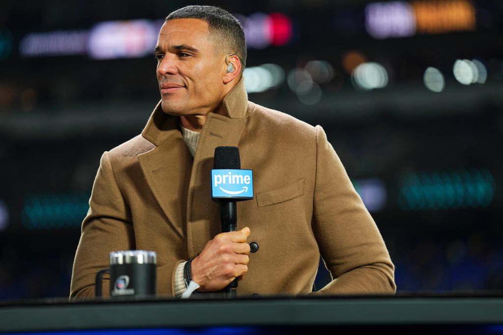 Tony Gonzalez in beige coat as he looks on from set prior to an NFL football wild card playoff game between the Pittsburgh Steelers and the Baltimore Ravens