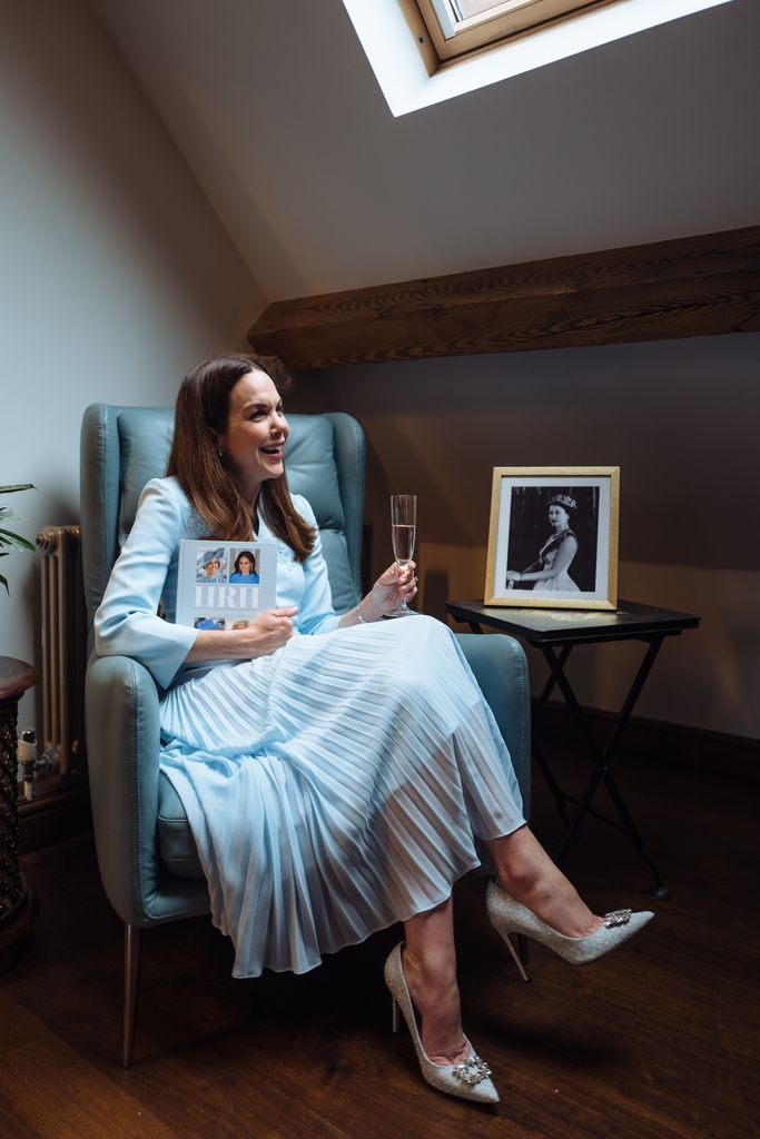Elizabeth reflects on the day and Charles III's late mum Elizabeth with a glass of bubbly and a copy of her NYT-bestselling book, HRH: So Many Thoughts on Royal Style