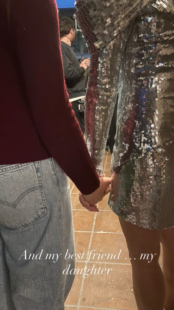 Sarah Michelle holding her daughter's hand