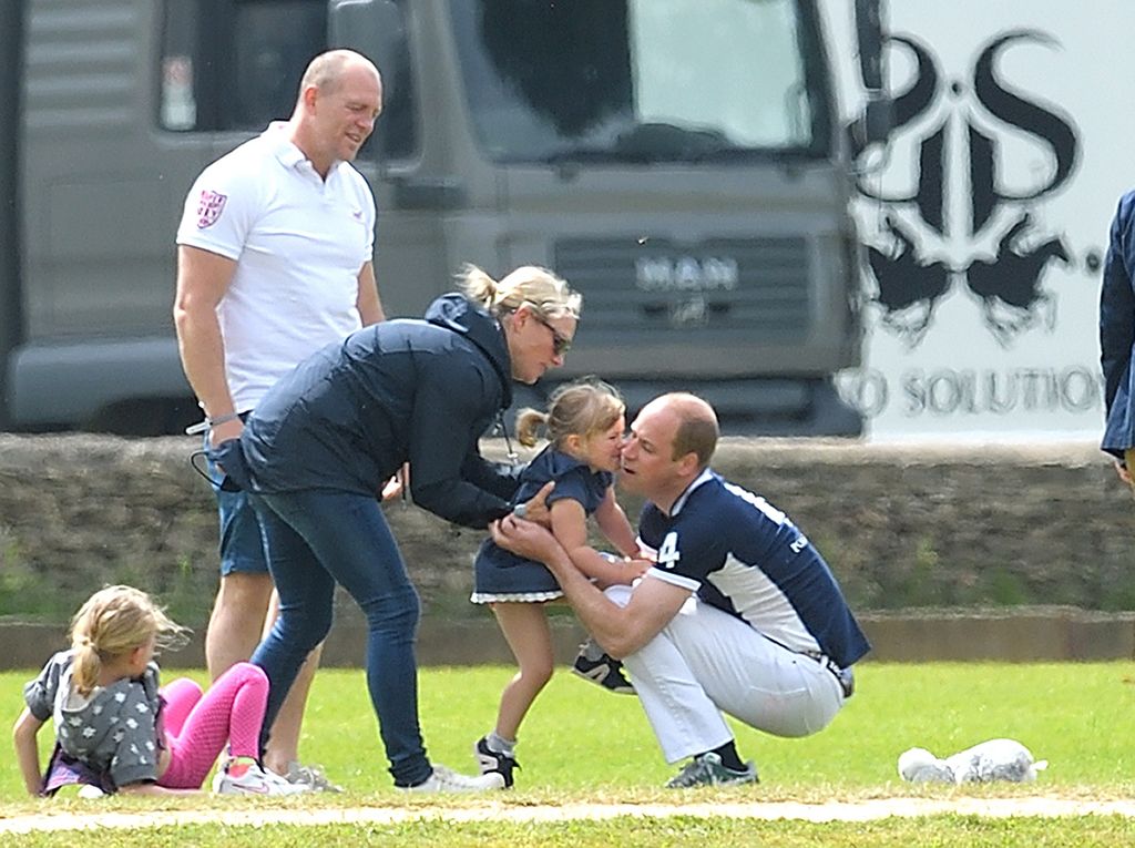 Mike and Zara Tindall watches daughter Mia get a hug from Prince William at the Maserati Royal Charity Polo Trophy on June 11, 2017 in Tetbury, England