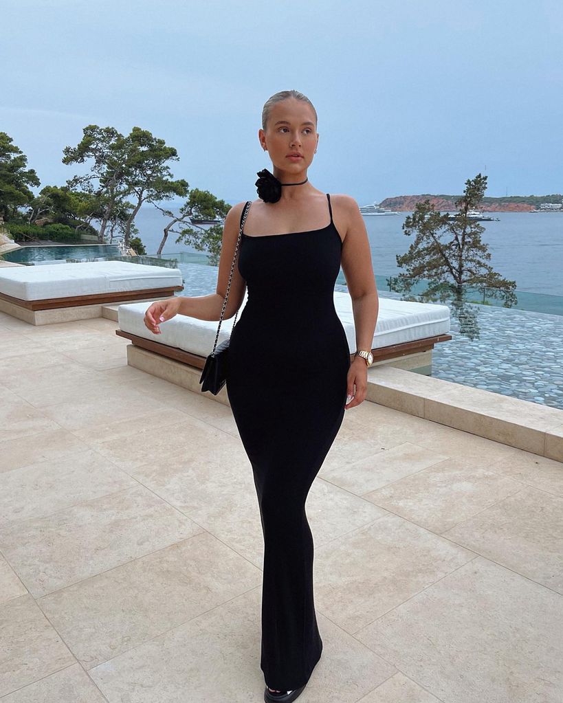 Molly Mae poses in a black dress while on holiday 