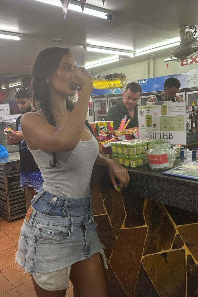 Maya Jama in denim mini skirt and grey tank yop