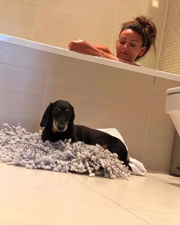 Michelle Keegan's dog curled up on her bath mat