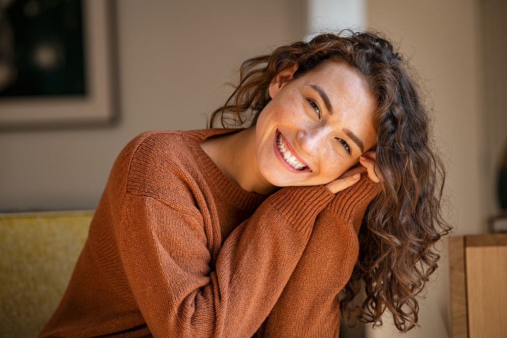 Happy woman smiling in cosy jumper