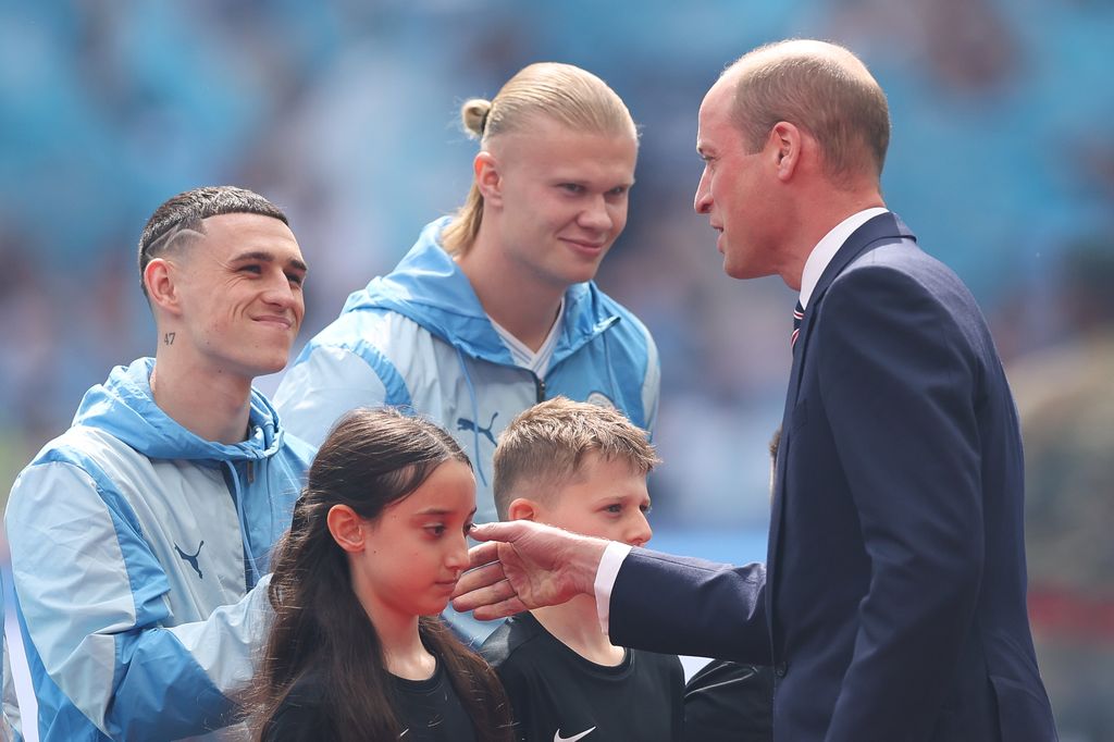 Prince William, Prince of Wales greets Phil Foden of Manchester City during the Emirates FA Cup Final match 