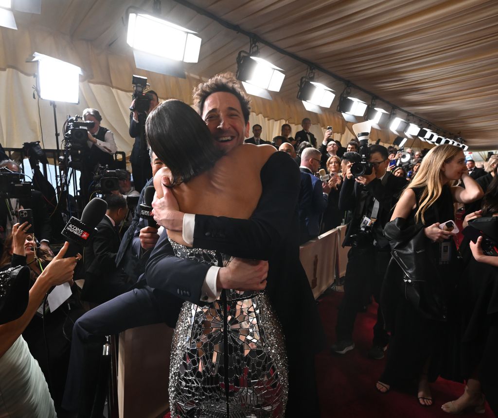 Halle Berry and Adrien Brody hugging on the red carpet at the 2025 Oscars