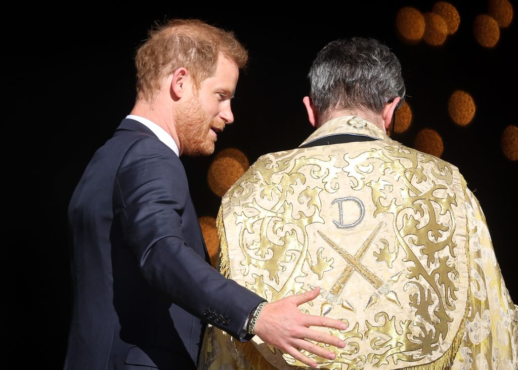 Prince Harry with his arm around a Dean