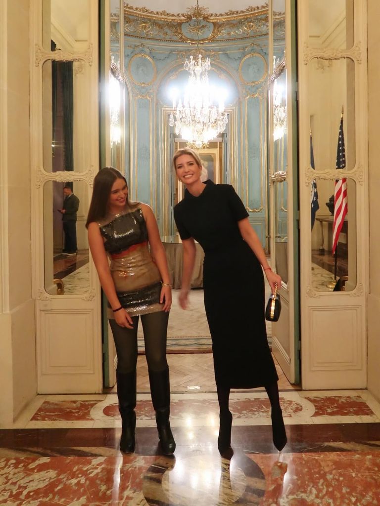 Ivanka Trump in black dress posing with her daughter
