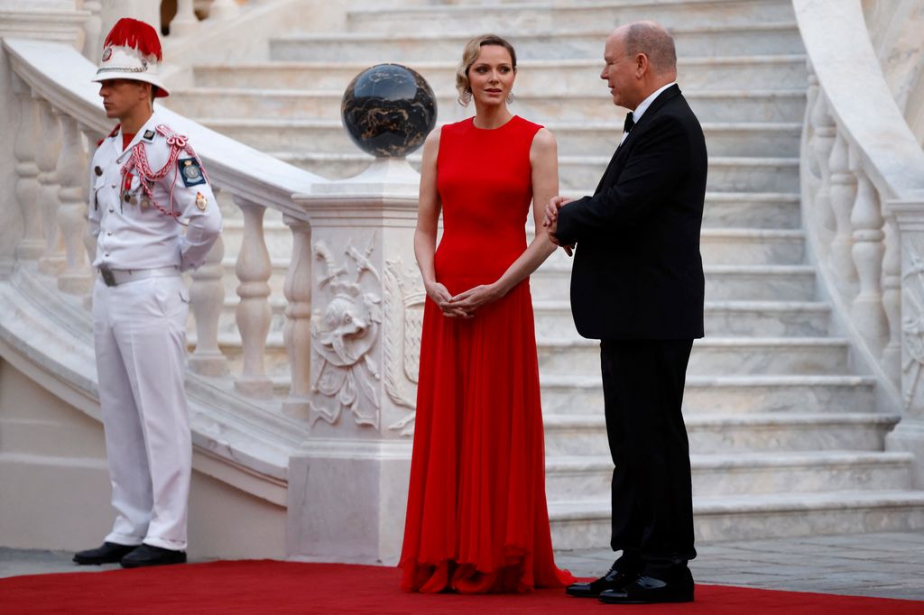 Prince Albert II of Monaco and Princess Charlene wait for their guests at the Prince's Palace before a state dinner with France's President