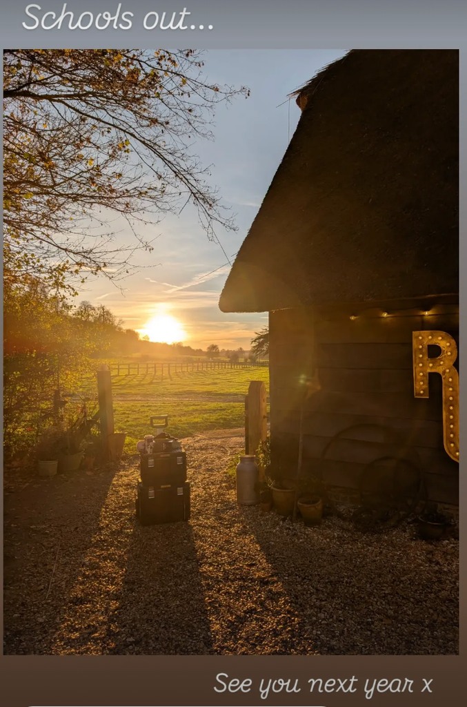 A photo of a sunset against a barn