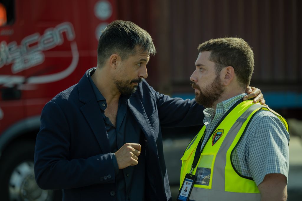 two men talking outdoors