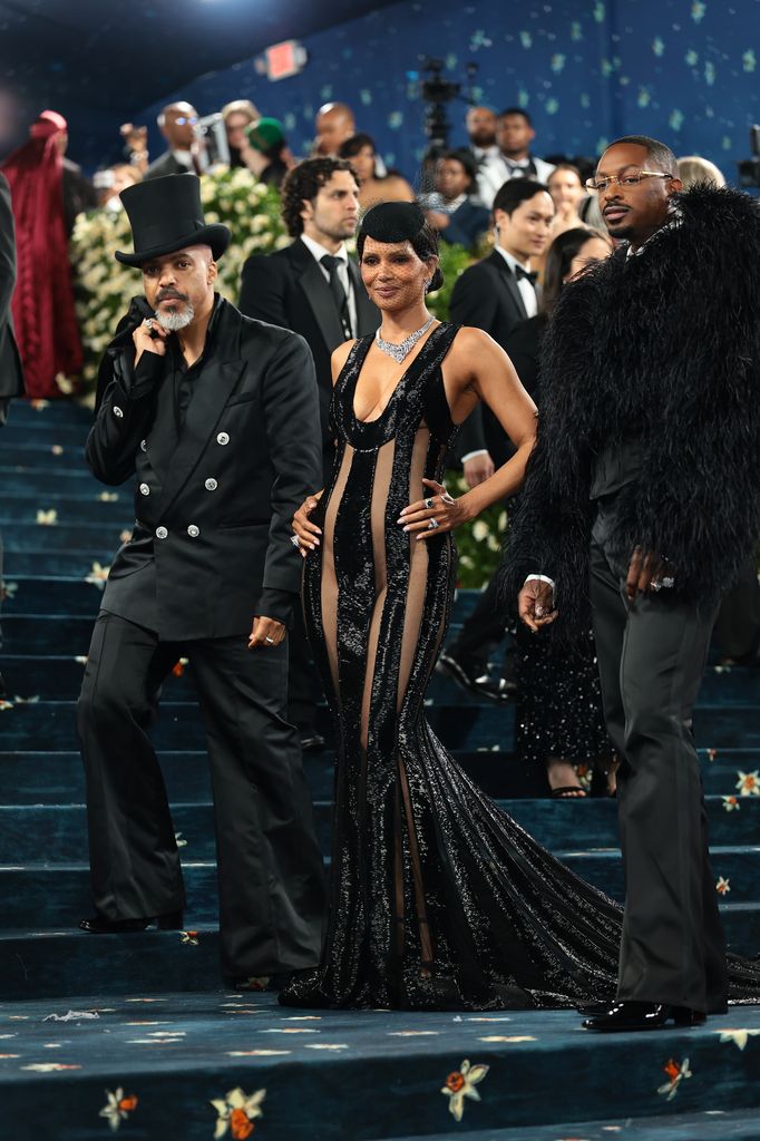 Van Hunt in black suit and Halle Berry in black dress and LaQuan Smith attend the 2025 Met Gala Celebrating "Superfine: Tailoring Black Style" at Metropolitan Museum of Art