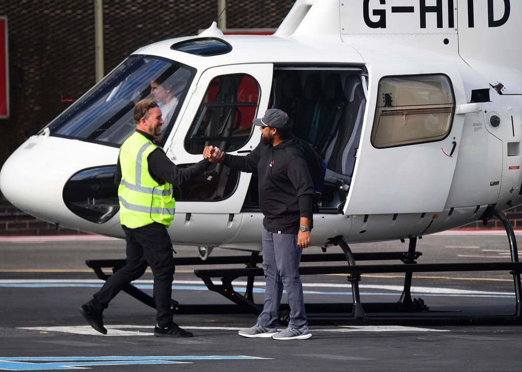 Connor Cruise shakes hands with heliport staff in London