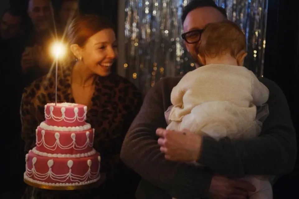 Stacey dooley holding birthday cake and Kevin clifton holding Minnie