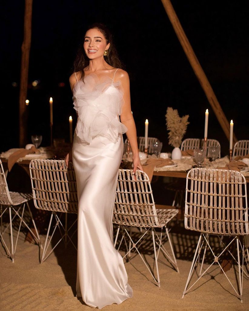 Olivia Culpo wearing a long satin dress for her bachelorette