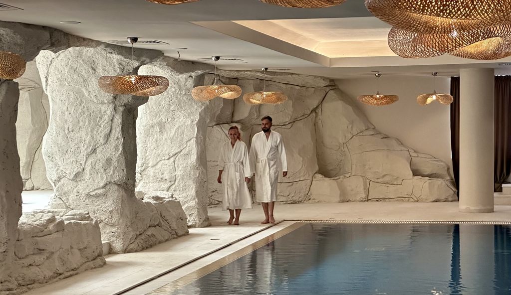 two people walking in spa with pool 