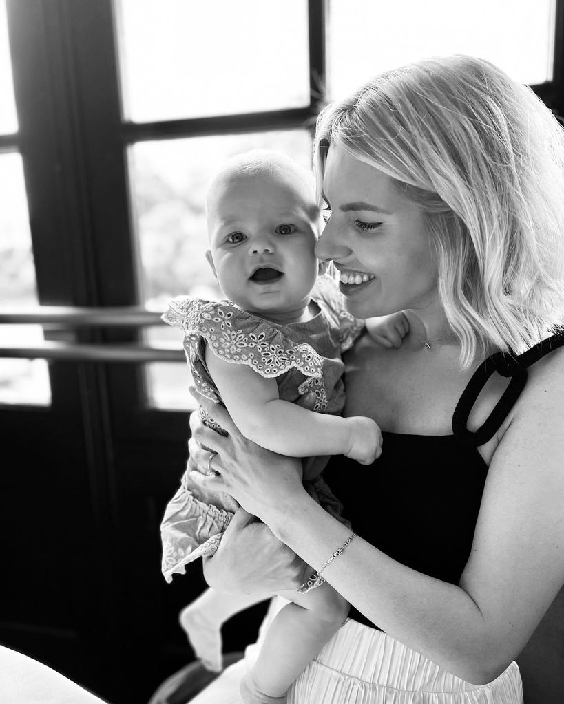 black and white mollie king holding baby