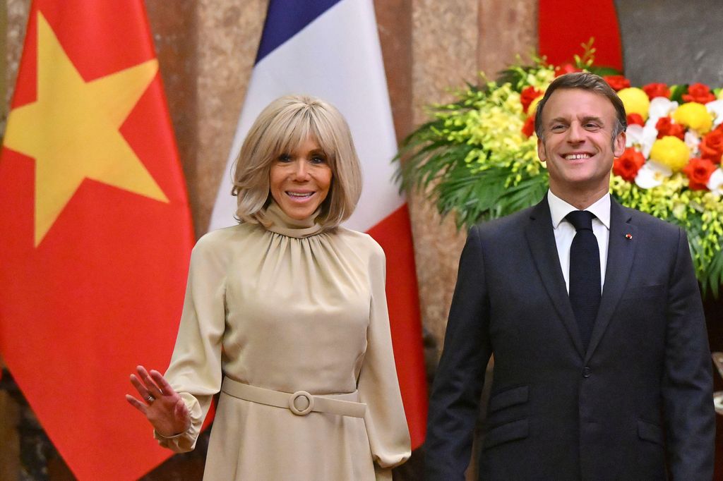 Brigitte Macron standing alongside Emmanuel Macron