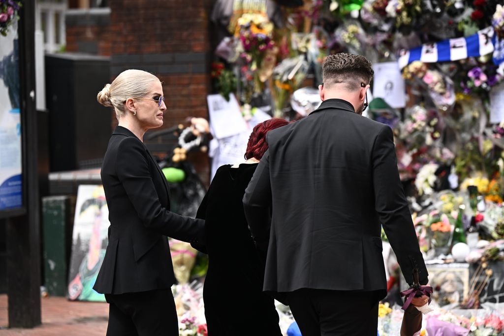 Kelly Osbourne, Sharon Osbourne and Jack Osbourne arrive to view tributes to the late Ozzy Osbourne from fans as his funeral cortege travels through his home city of Birmingham