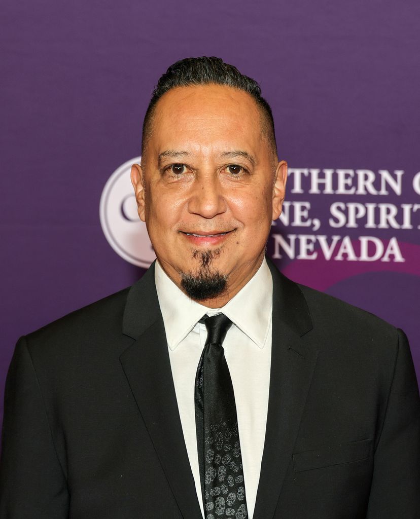 Cleto smiling in a suit