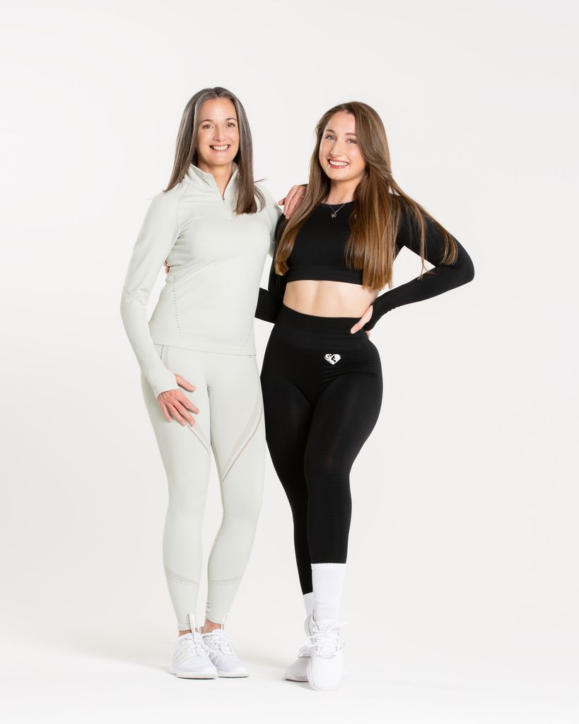 Two women with long straight hair smiling for the camera 