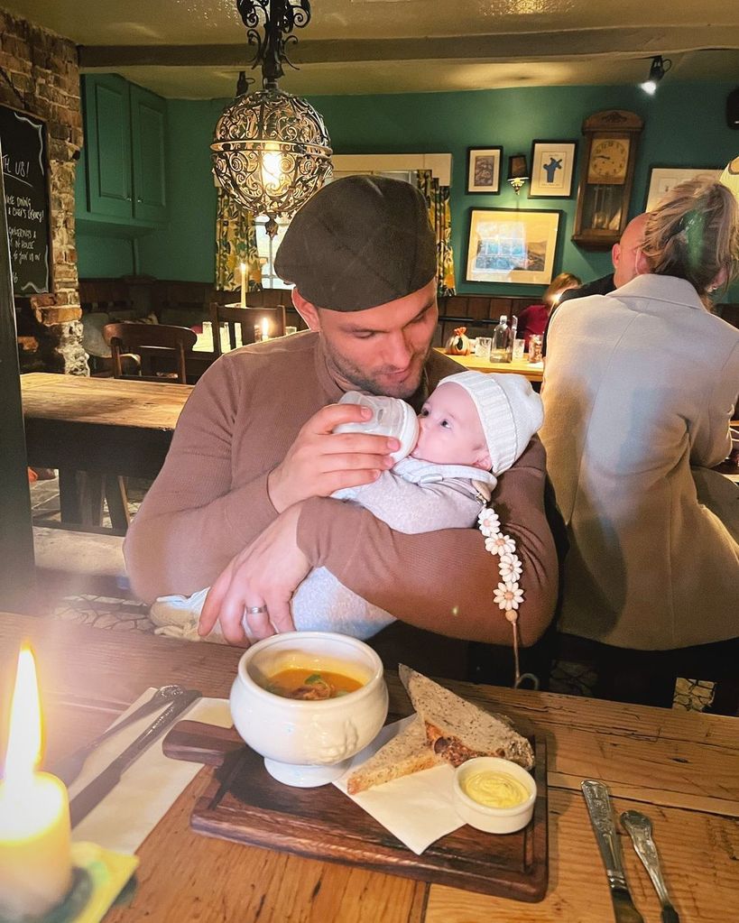 Aljaz Skorjanec feeding baby Lyra during a pub lunch