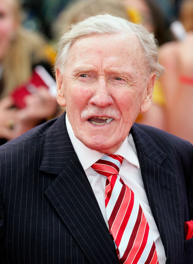 Leslie Phillips in a pinstripe suit