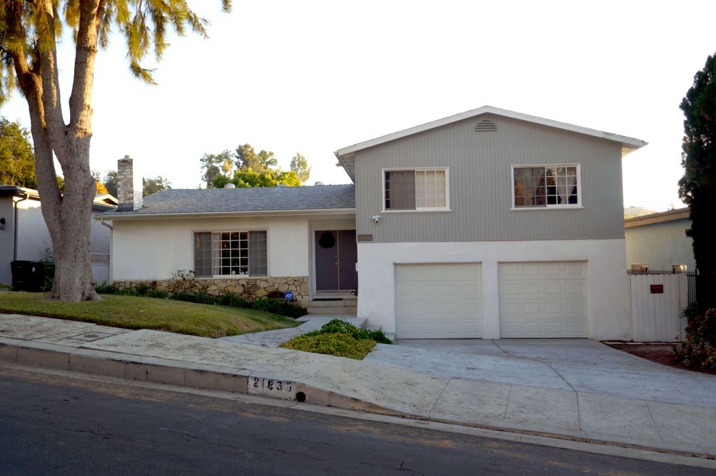 exterior of grey home with tidy front garden