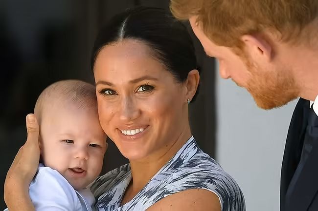 meghan markle smiling holding baby archie