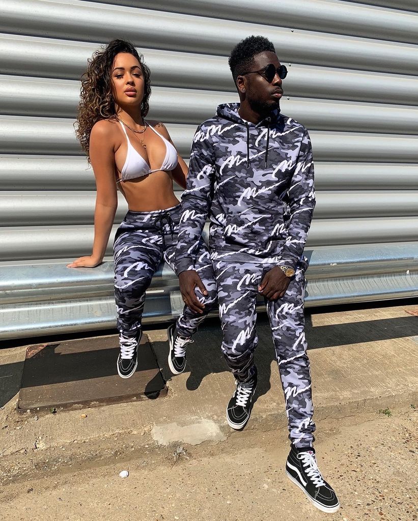 marcel and rebecca in matching camo tracksuits