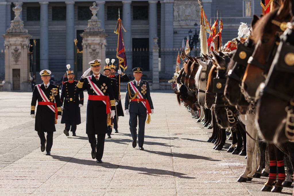 King Felipe VI walks by military on horseback
