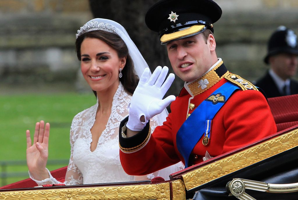 Prince William and Kate Middleton waving to crowds following their royal wedding in 2011