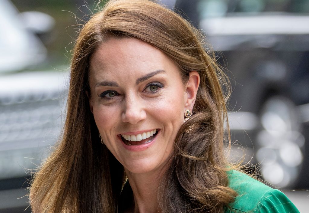 Kate Middletom with curly brunette hair green dress and Accessorize earrings