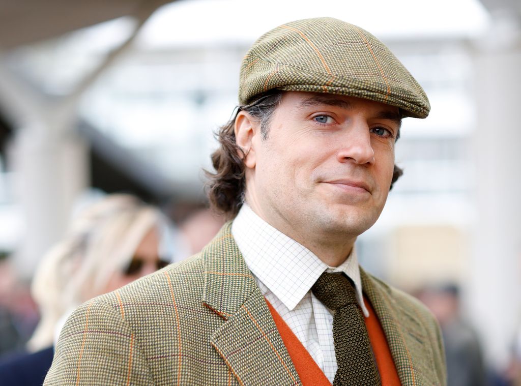 Henry Cavill in a suit and cap at Cheltenham Festival