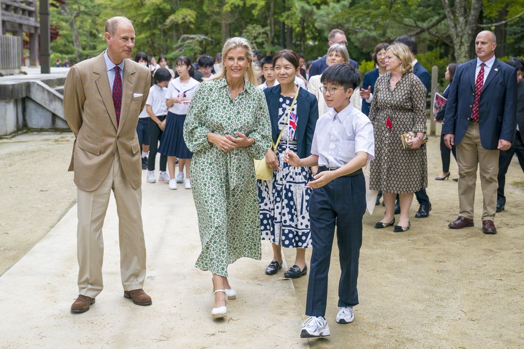 The Duke and Duchess of Edinburgh outside surrounded by people