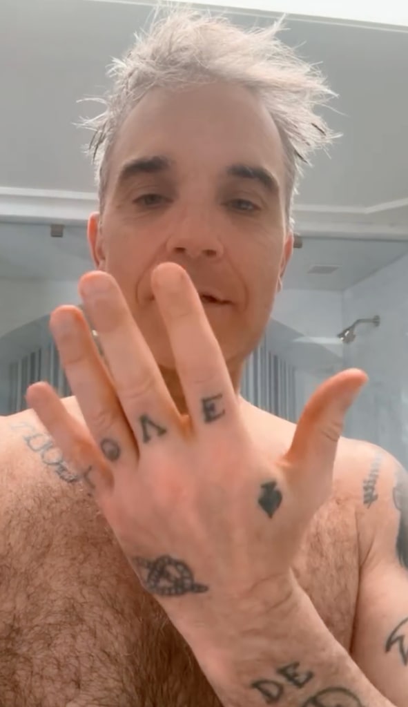 A photo of a shirtless Robbie Williams