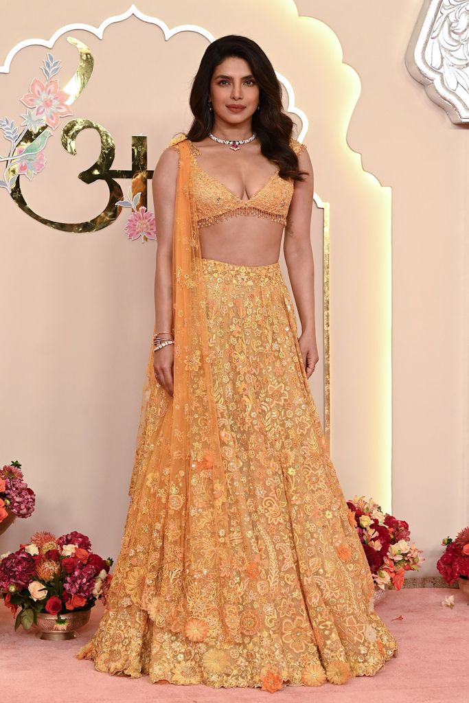 Priyanka Chopra Jonas poses for photos as she arrives to attend the wedding ceremony of billionaire tycoon and Chairman of Reliance Industries Mukesh Ambani's son Anant Ambani and Radhika Merchant in Mumbai on July 12, 2024.